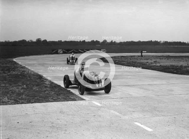 Rapier Special Racing single seater leading a MG in a race on the Campbell Circuit at Brooklands. Artist: Bill Brunell.