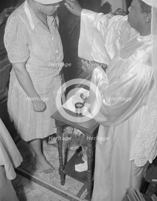 Reverend Clara Smith anointing a member of the St. Martin's Spiritual... Washington, D.C., 1942. Creator: Gordon Parks.