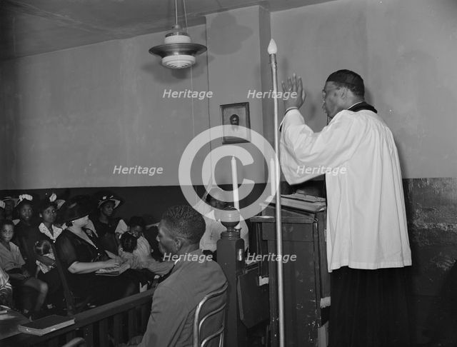 Reverend Vondell Gassaway, pastor of the St. Martin's Spiritual Church..., Washington, D.C., 1942. Creator: Gordon Parks.