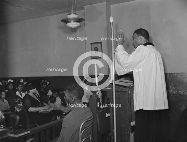 Reverend Vondell Gassaway, pastor of the St. Martin's Spiritual Church..., Washington, D.C., 1942. Creator: Gordon Parks.