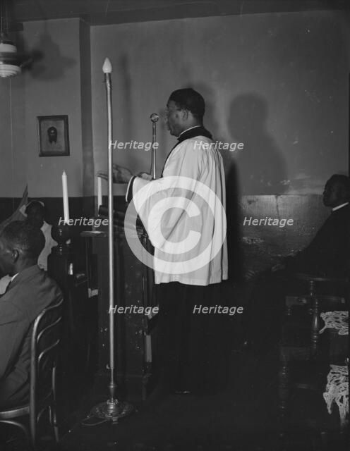 Reverend Vondell Gassaway, pastor of the St. Martin's Spiritual Church..., Washington, D.C., 1942. Creator: Gordon Parks.