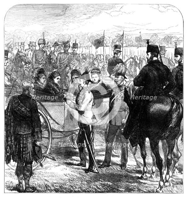 Review at Windsor: the Queen presenting the Cross of...St. George to Sir Garnet Wolseley, 1874. Creator: Unknown.