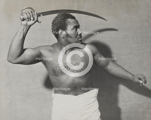 Rex Ingram, shirtless, with cutlass, 1938. Creator: Unknown.