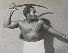 Rex Ingram, shirtless, with cutlass, 1938. Creator: Unknown