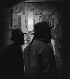 Reading wall notices, Chinatown, San Francisco, between 1896 and 1906. Creator: Arnold Genthe