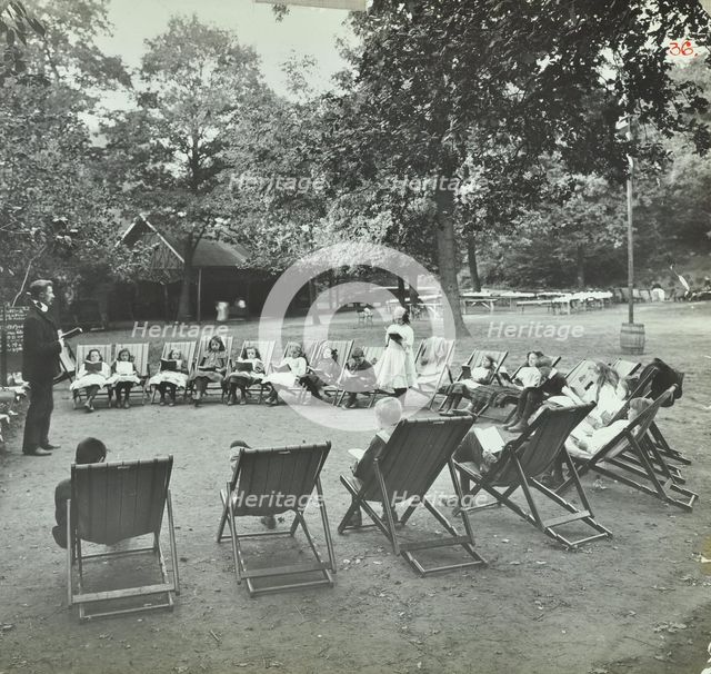 Reading lesson outside, Bostall Woods Open Air School, London, 1907. Artist: Unknown.