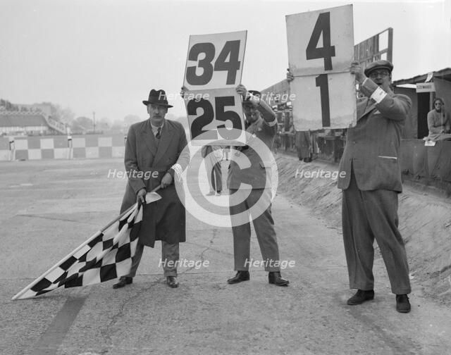 Ready to wave the chequerd flag, Brooklands. Artist: Bill Brunell.