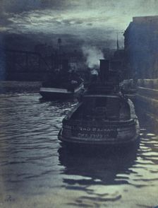 Rear view of tugboats approaching a wharf, possibly in Cleveland, Ohio, 1903. Creator: Unknown
