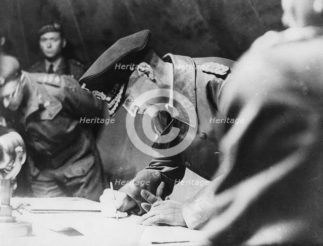 Rear-Admiral Gerhard Wagner signing the German surrender document ending World War II, 1945. Artist: Unknown