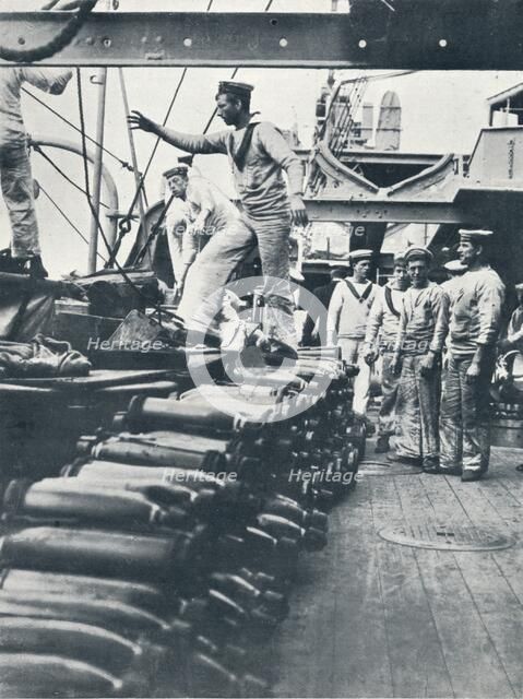 Receiving shells for the naval guns on the deck of a battleship, c1914. Artist: Unknown