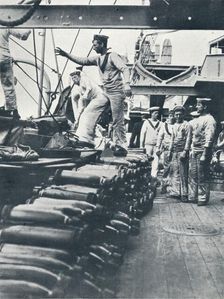 Receiving shells for the naval guns on the deck of a battleship, c1914