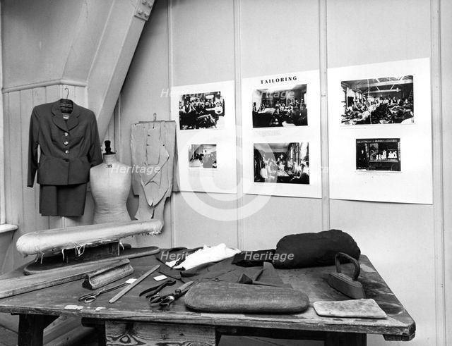 Reconstruction of a tailor's workshop in London's East End. Creator: Sidney Harris.