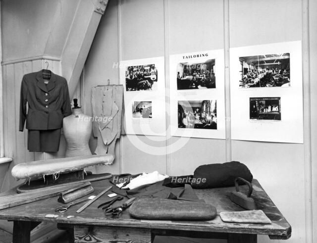 Reconstruction of a tailor's workshop in London's East End. Artist: Sidney Harris