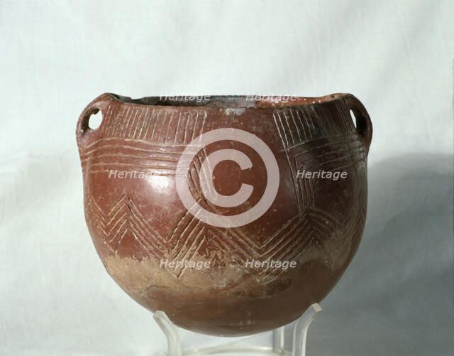 Red ochre glass (painted with a red slip of iron oxide), with incised parallel lines that form ge…
