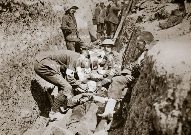 Red Cross men in the trenches tend a wounded man, Somme campaign, France, World War I, 1916. Artist: Unknown