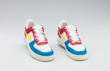 Red, white, yellow, and blue Nike sneakers worn by Big Boi of Outkast, 2005-2006. Creator: Nike
