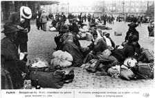 Refugees from the north waiting for a guide to find them lodgings, Paris, World War I, 1914-1918