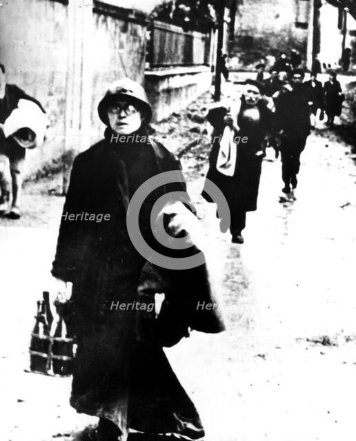 Refugees leaving a Normandy town, France, World War II, 1940-1944. Artist: Unknown