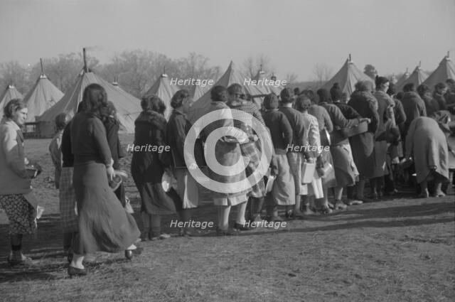 Refugees lined up at meal time in the camp for white flood refugees in Forest City, Arkansas, 1937. Creator: Walker Evans.