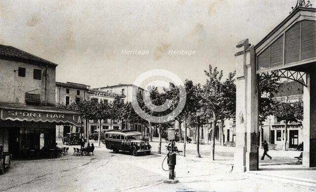 Regular bus at the stop of the bar Sport in Santa Coloma de Farners (Girona), on a postcard from …