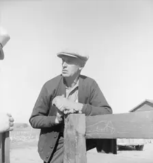 Rehabilitation client talking over fence with county supervisor, near Stockton, CA, 1938. Creator: Dorothea Lange