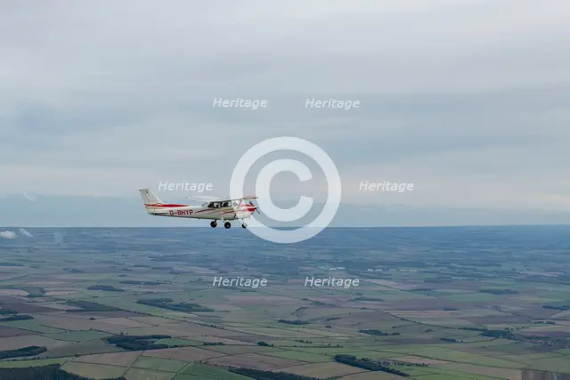 Reims-Cessna F172M Skyhawk in flight near Driffield, East Riding of Yorkshire, 2023. Creator: Chloe Pearson Jones.