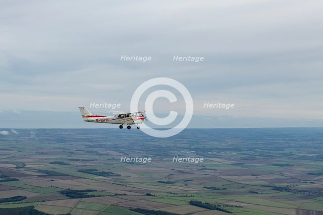 Reims-Cessna F172M Skyhawk in flight near Driffield, East Riding of Yorkshire, 2023. Creator: Chloe Pearson Jones.