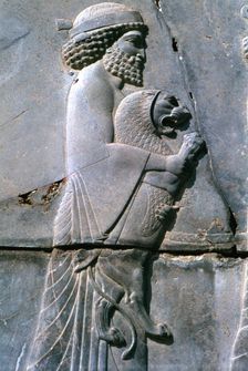 Relief of a man holding a lion cub, Persepolis, Iran. Creator: Vivienne Sharp