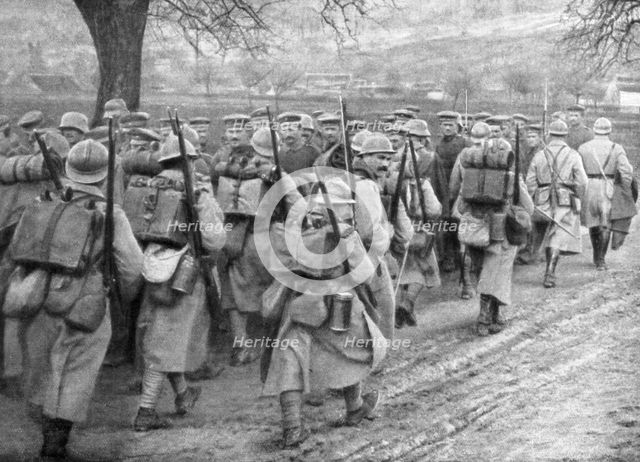 Relief French infantry passing a line of prisoners, Plessis-de-Roye, Picardy, France, 30 March 1918. Artist: Unknown