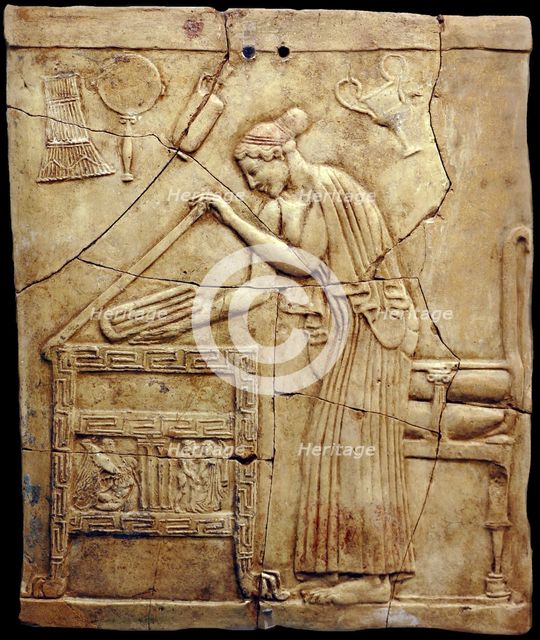 Relief pinax from Locri depicting a woman placing laundry in a laundry chest, Mid of the 5th cen. BC Creator: Classical Antiquities.