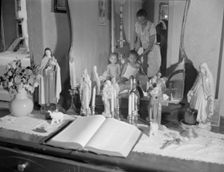 Religious objects and an improved altar in the bedroom..., Washington, D.C., 1942. Creator: Gordon Parks