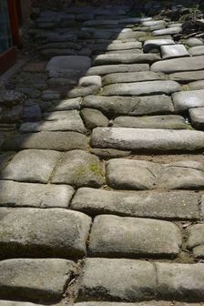 Remains of a Roman road next to the Valmardon Gate, paved with granite slabs, Toledo, Spain, 2022. Creator: LTL