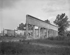 Remains of storefronts in Fullerton, Louisiana, an abandoned lumber town, 1937. Creator: Dorothea Lange