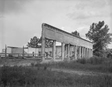 Remains of storefronts in Fullerton, Louisiana, an abandoned lumber town, 1937. Creator: Dorothea Lange