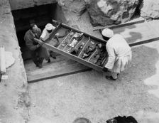 Removing a tray of chariot parts from the Tomb of Tutankhamun, Valley of the Kings, Egypt, 1922. Creator: Harry Burton