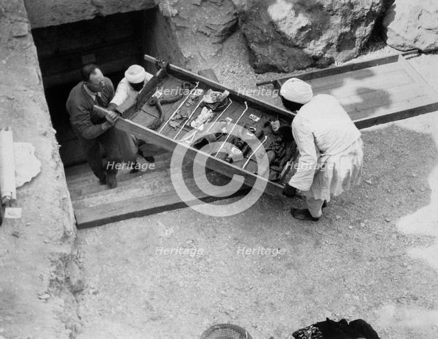 Removing a tray of chariot parts from the Tomb of Tutankhamun, Valley of the Kings, Egypt, 1922. Creator: Harry Burton.