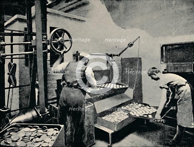 'Removing Biscuits from Oven', c1917. Artist: Unknown.