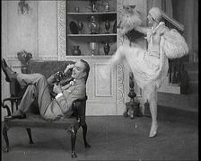 Renee Gadd Dancing Around George Grossmith Who Is Desperately Trying to Make a Phone Call..., 1920s. Creator: British Pathe Ltd