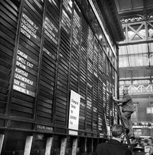 Repairing the departure board at Victoria Station, London, 1960-1972. Artist: John Gay