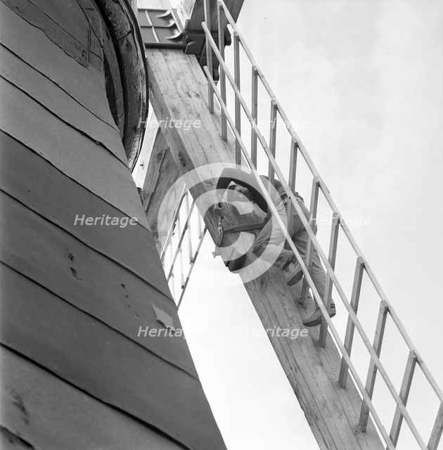 Repairing the sails of a windmill, Säbyholm, Sweden, 1964. Creator: Unknown.
