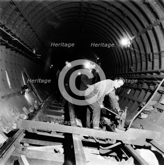 Repairing underground train tracks, London, 1955. Creator: Henry Grant.