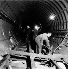 Repairing underground train tracks, London, 1955. Creator: Henry Grant