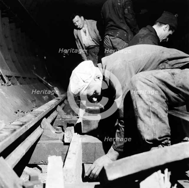 Repairing underground train tracks, London, 1955. Creator: Henry Grant.