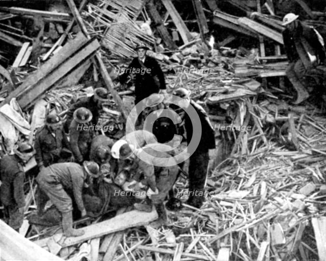 Rescue workers releasing a man from a bomb damaged building, World War II, 1940. Artist: Unknown