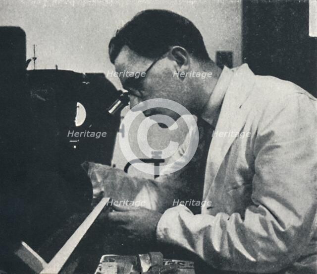 'Research worker with microscope (testing the structure of an aluminium alloy)', 1941. Artist: Cecil Beaton.