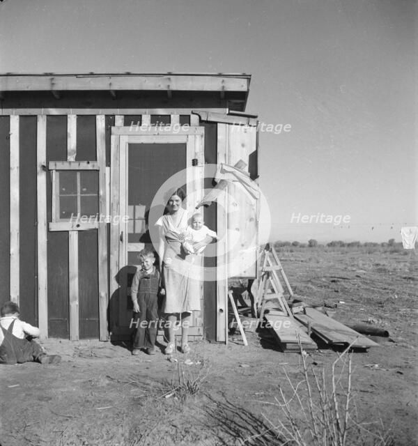Resettled at Bosque Farms project - family of four from Taos Junction, 1935. Creator: Dorothea Lange.