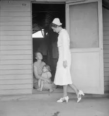 Resident nurse come to visit family, FSA camp, Farmersville, Tulare County, 1939. Creator: Dorothea Lange