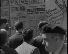 Residents of Madrid Looking at Government Posters on a Wall, 1937. Creator: British Pathe Ltd