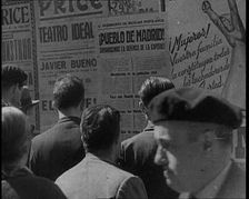 Residents of Madrid Looking at Government Posters on a Wall, 1937. Creator: British Pathe Ltd