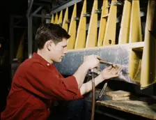 Riveter at work at the Douglas Aircraft Corporation plant in Long Beach, Calif., 1942. Creator: Alfred T Palmer